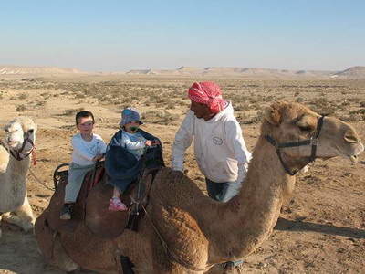 Maayan and Lotem riding a camel